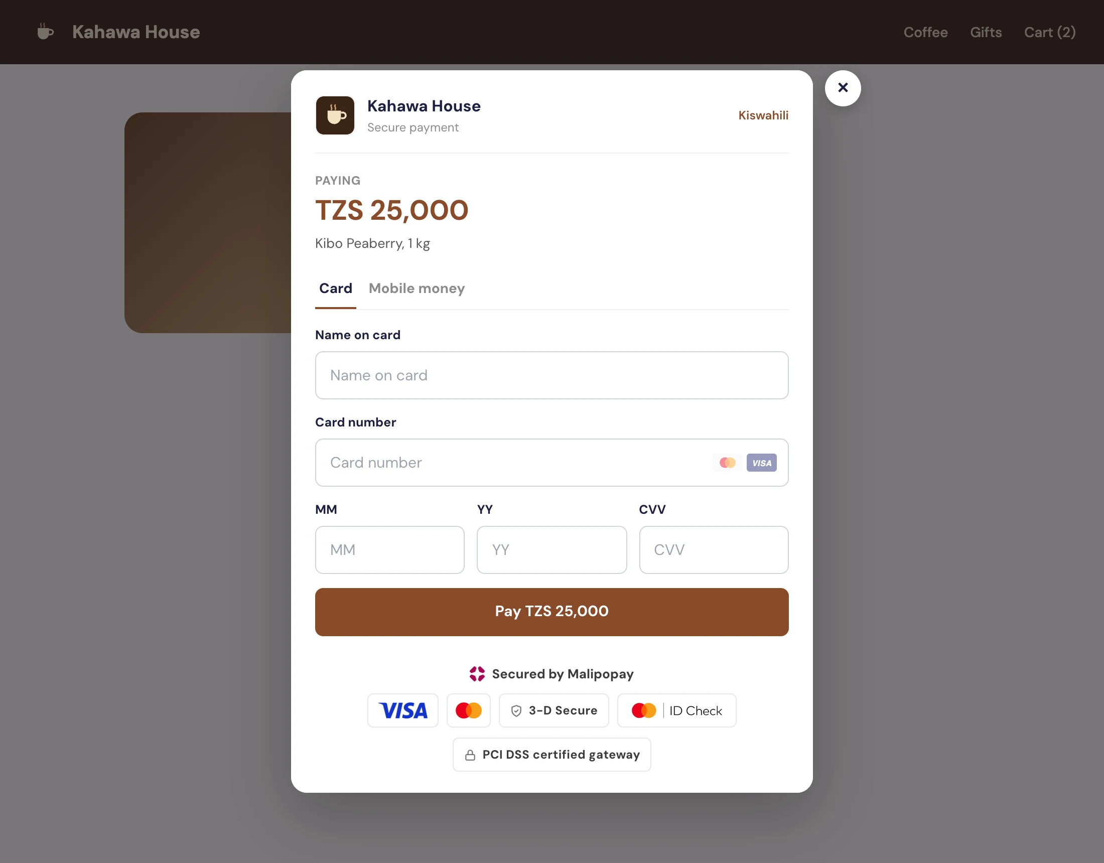 A product page dimmed behind a checkout window that shows the Kahawa House header, the amount and the card form
